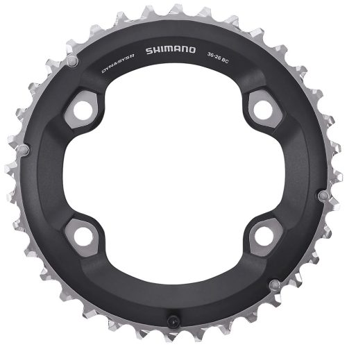 Svart och silverfärgad Shimano-kedjekrans för cykel med 36 tänder, med fyra monteringshål och modellinformation tryckt på ytan. Tänderna är jämnt fördelade runt ytterkanten.