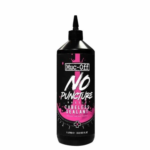 En svart 1-litersflaska med Muc-Off No Puncture Hassle Tubeless Sealant med ett spetsigt applikatorlock. Etiketten har rosa och vit text och grafik på en svart bakgrund.