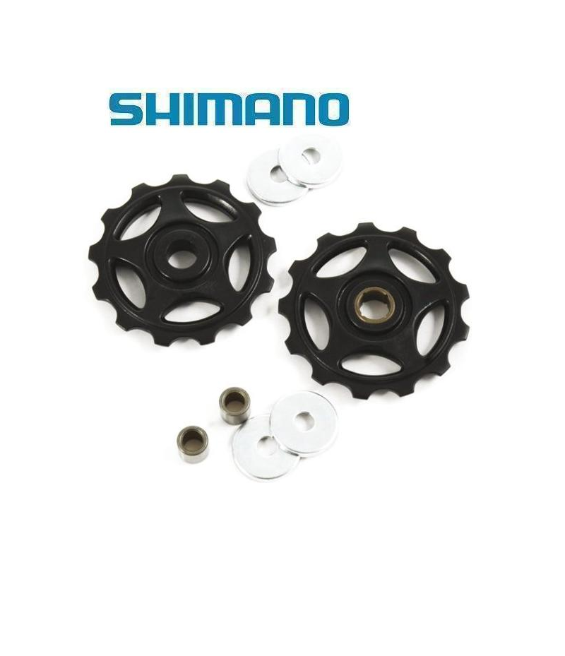 Shimano-Rulltrissor-m410.png Två svarta Shimano cykelväxelhjul med fyra metallbrickor och fyra cylindriska bussningar mot en vit bakgrund. Den blå Shimano-logotypen visas ovanför komponenterna.