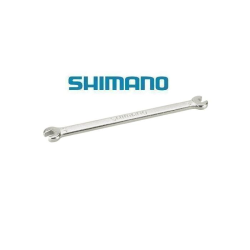 En metallisk dubbeländad öppen skiftnyckel är avbildad under den blå Shimano-logotypen på en vit bakgrund. Skiftnyckeln ser ut att vara ett cykelverktyg.