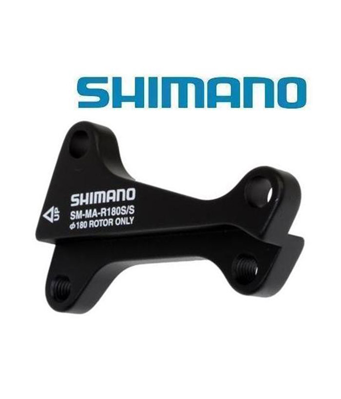 Shimano-skivbromsadapter-fram-180mm-gaffel-Int-std-ok-Int-std.jpg En svart Shimano SM-MA-R180S/S bromsadapter visas mot en vit bakgrund med den blå Shimano-logotypen ovanför. Adaptern har modellinformation och monteringsdetaljer tryckta med vita bokstäver.