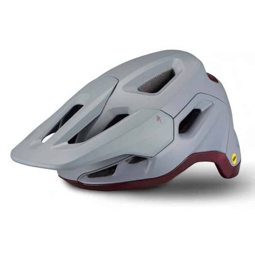 En grå och rödbrun cykelhjälm med flera ventilationsöppningar och visir, utformad för mountainbikecykling. Hjälmen har stoppning på insidan och en liten gul logotyp på sidan.