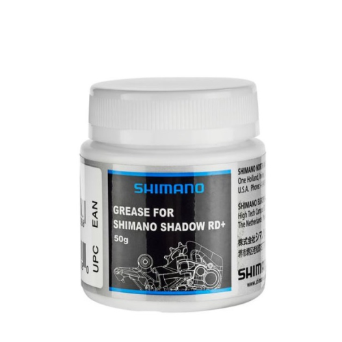 En vit plastburk märkt "Shimano Grease for Shimano Shadow RD+, 50g" med en svart och blå design och en illustration av cykelkomponenter på framsidan. Burken har ett vitt skruvlock.