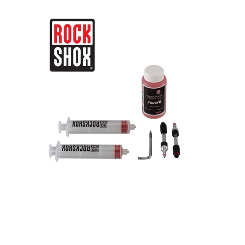 Avluftningssats av märket RockShox med två sprutor, en flaska med vätska, en insexnyckel och små metallkontakter och kopplingar mot en vit bakgrund. RockShox logotyp visas i det övre vänstra hörnet.