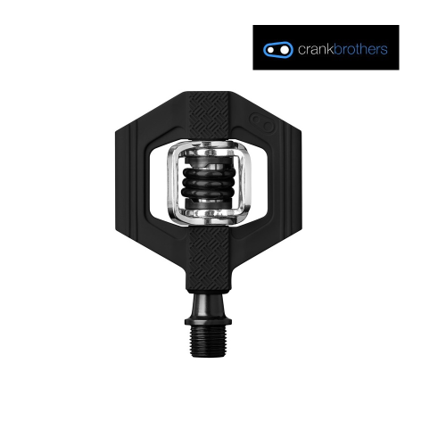 En svart Crankbrothers cykelpedal med hexagonal design och synlig fjädermekanism visas mot en vit bakgrund. Crankbrothers logotyp visas i det övre högra hörnet.