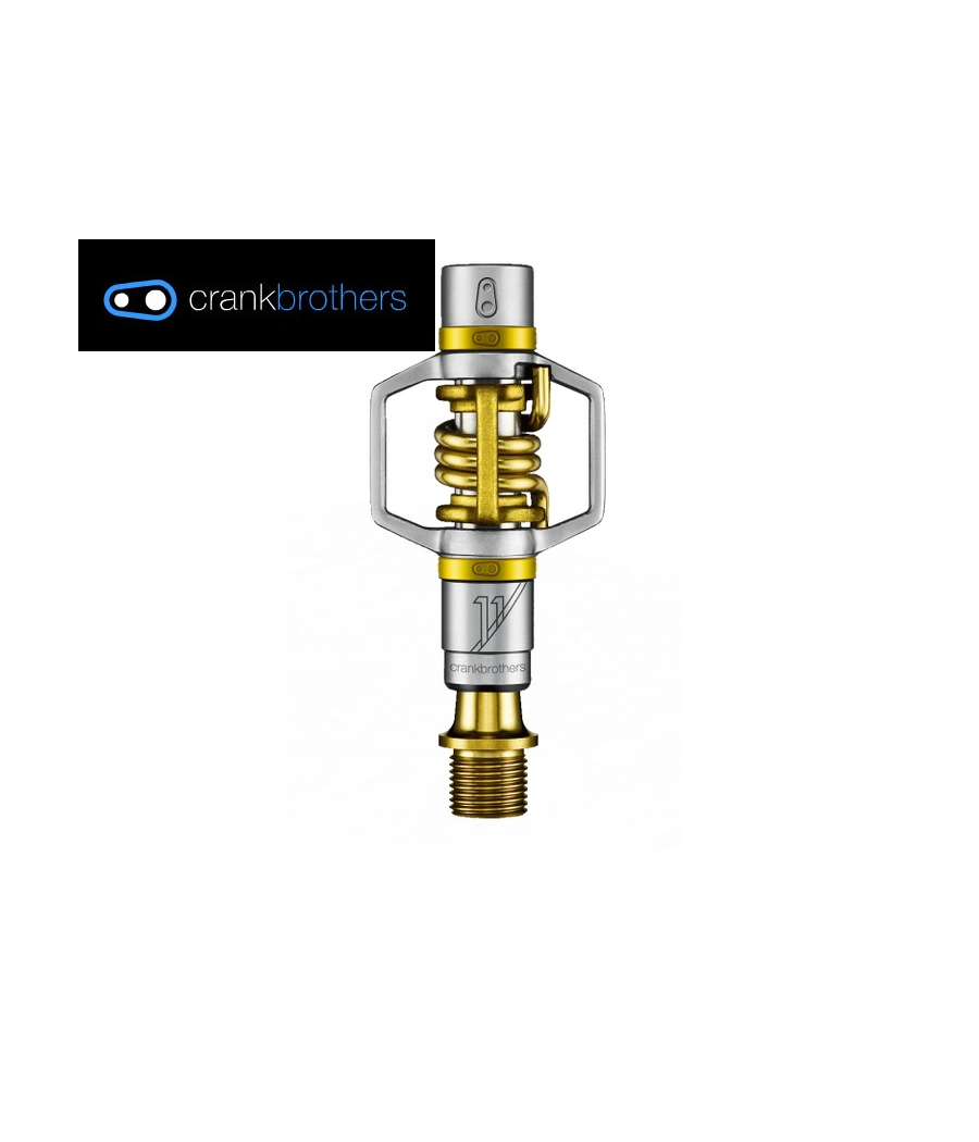 pedaler-crankbrothers-eggbeater-11.png En cykelpedal från Crankbrothers i silver- och guldfärg visas mot en vit bakgrund. Crankbrothers logotyp visas i det övre vänstra hörnet.