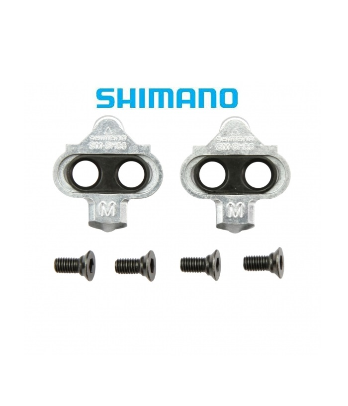 shimano-spd-56-utan-platta.png Två Shimano SM-SH56 cykelklämmor med fyra skruvar placerade under dem, på en vit bakgrund med Shimano-logotypen ovanför.