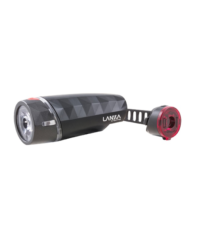 spanninga.lanza_.dot_.lampset.png En uppsättning svarta cykellampor, inklusive en främre LED-strålkastare med geometriskt mönster och en bakre röd lampa fäst vid ett svart gummiband.