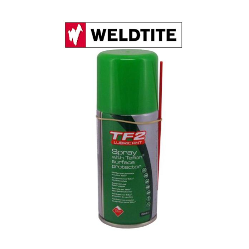 En burk TF2 Lubricant Spray med Teflon Surface Protector från Weldtite. Burken har grönt lock och etikett och visas under en Weldtite-logotyp med röd och svart text.