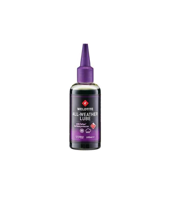 All-weather_Lube.jpg En flaska Weldtite All-Weather Lube kedjeolja, 100 ml, med mörklila kork, mot en neutral bakgrund. Etiketten betonar produktens lämplighet för alla väder.
