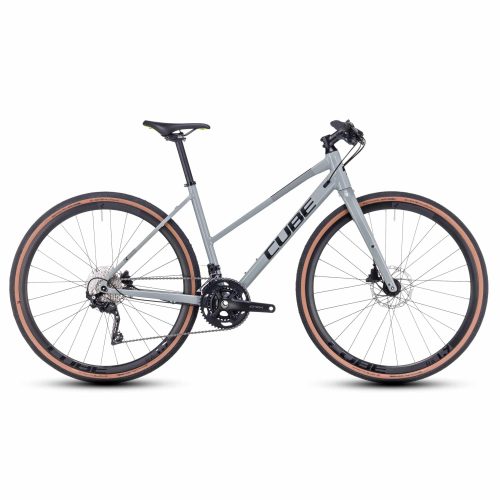 En Sport/Hybrid Cube Nulane Pro Dam-cykel i grått med genomgående ram, platt styre, skivbromsar och däck med bruna kanter, visad från sidan mot en vit bakgrund.