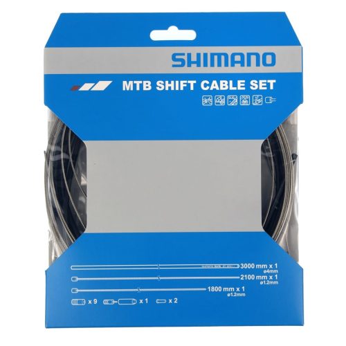 En förpackning med ett Shimano MTB växelvajerset visas i en detaljerad närbild. Förpackningen har en blå och grå färgskala med tydlig produktinformation och kablarna syns genom en genomskinlig öppning.