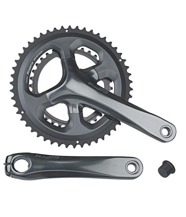 Shimano-Tiagra-52-36T.jpg Detaljerad bild av ett Shimano FC-4700 Tiagra 10-växlat vevparti (52/36T) mot en vit bakgrund. Metallisk grå finish framhävs av ljuset som reflekteras på ytan.