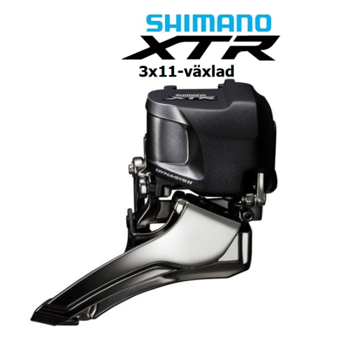 Detaljerad bild av en Shimano XTR Di2 FD-M9050 framväxel. Den har en mörkgrå ovandel och en kromad kåpa, med tydlig märkning. Professionellt belyst för att framhäva produktens finish och design.