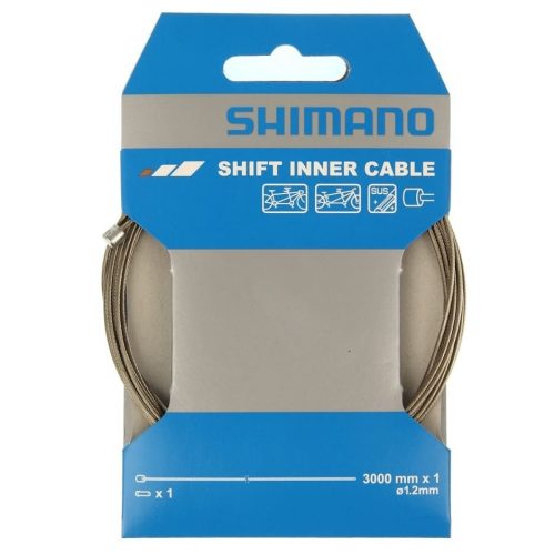 En förpackning Shimano växelvajer, rostfri och extra lång, med dimensionerna 1,2 x 3000 mm. Förpackningen har en ljusblå och grå färgskala, tydligt märkt med Shimano-logotypen. Vajaern är synlig genom ett fönster i förpackningen.