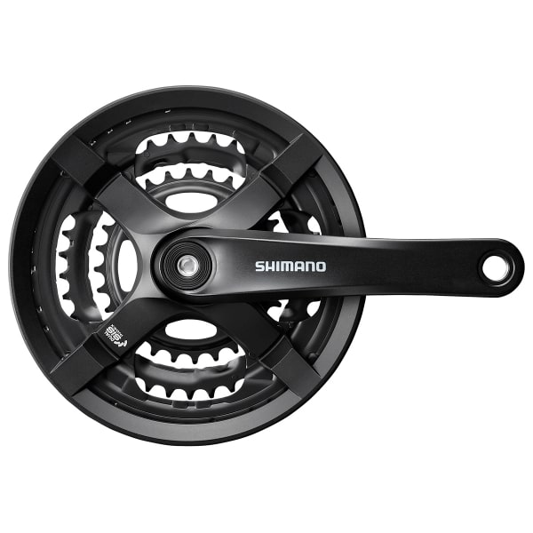 TY-FC501.jpg Vevparti Shimano FC-TY501 i svart, en detaljerad bild som visar tre kedjekransar och vevarmen med Shimano-logotypen. Jämn belysning framhäver de komplexa detaljerna i mekanismen.