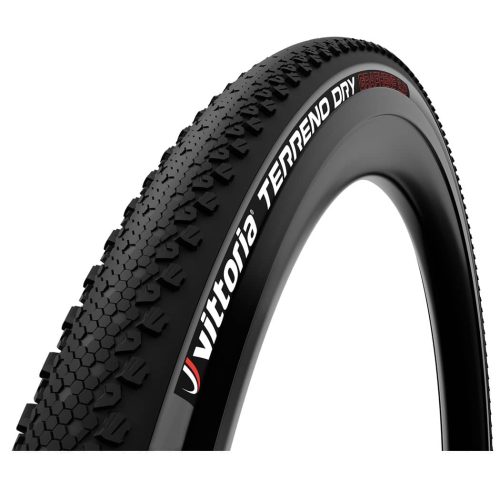 Ett Vittoria Terreno Dry TNT grusdäck visas i en studio. Däcket är antracitgrått och svart, tubeless ready. Texten 'Vittoria TERRENO DRY GRAPHENE 2.0' syns tydligt i rött och vitt.