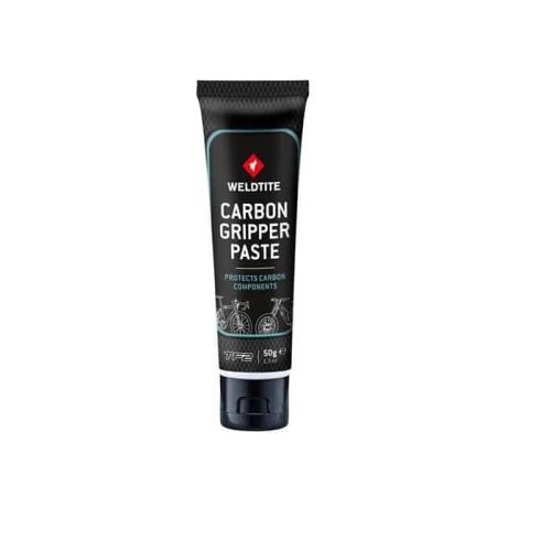 En tub Weldtite Carbon Gripper Paste, en monteringspasta för kolfiberkomponenter. Tuben är svart med blå detaljer och vit text. Bilden är tagen i bra ljus med vit bakgrund.