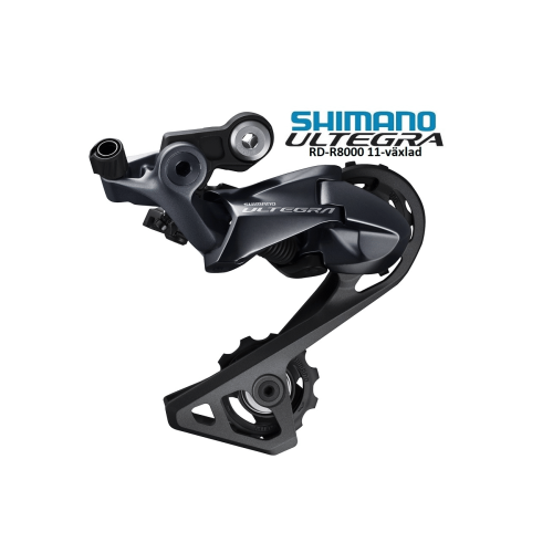 Detaljerad bild av en Shimano Ultegra RD-R8000 11-växlad bakväxel. Metallisk grå finish fångas i ett mjukt ljus, vilket framhäver de precisa mekaniska detaljerna och den höga kvaliteten.
