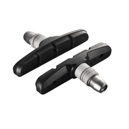 Två svarta Shimano Alivio/Acera M330 bromsklossar, belysta med starkt ljus som framhäver detaljerna. Den silverfärgade fästpunkten kontrasterar mot det matta svarta gummit.