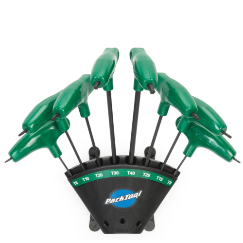 Närbild av ett ParkTool PH-T1.2 Torx®-nyckelset i en svart hållare, åtta gröna L-formade nycklar står ordnade med storleksmarkeringar i en väl upplyst miljö.