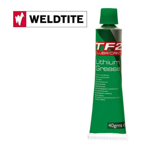 En grön tub med Weldtite TF2 litiumfett visas i bra ljus och detalj. Texten på tuben är tydlig och läsbar, atmosfären är ren och professionell.