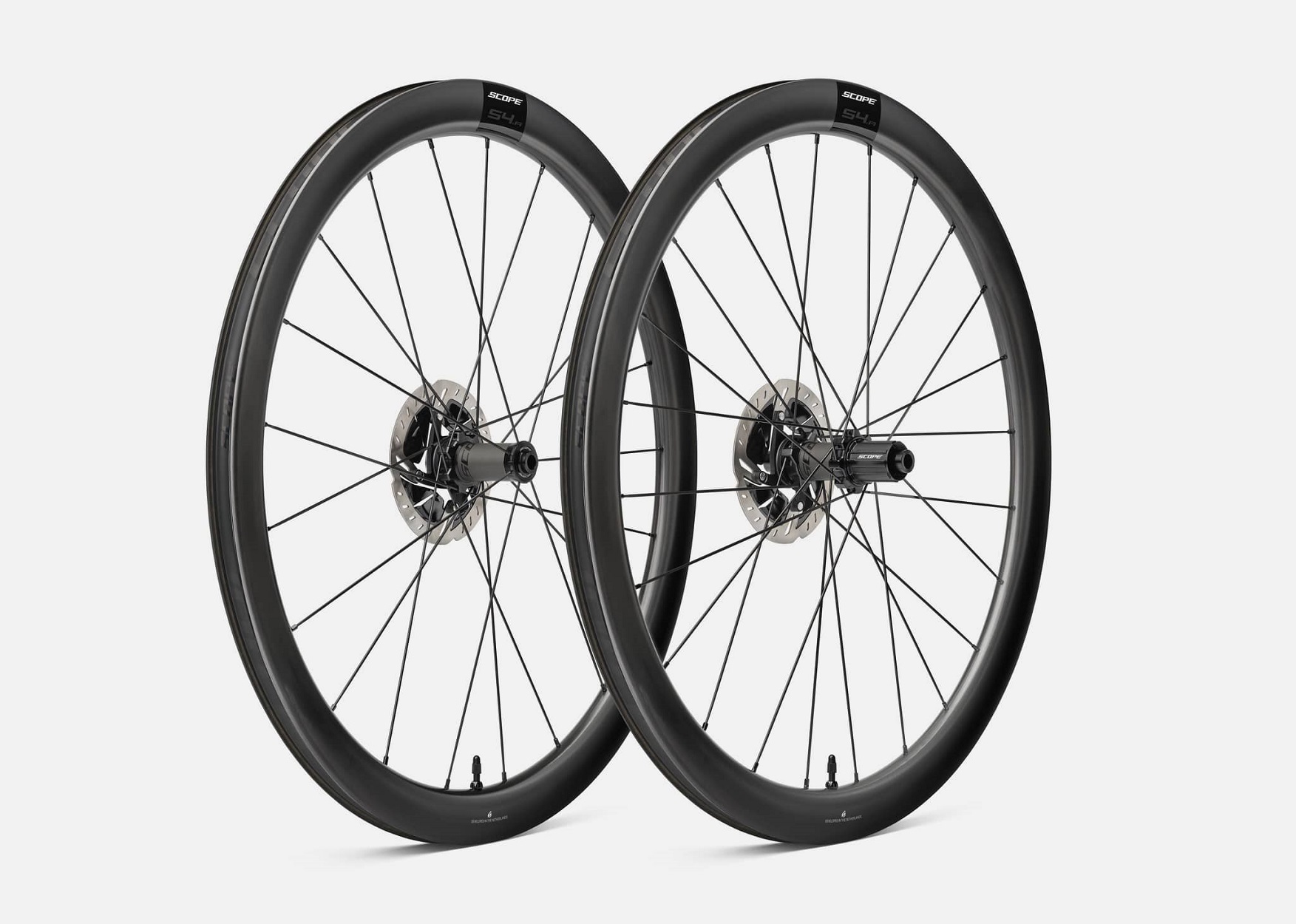 Scope S4a-wheelset-Gravel 1 Två Scope S4.A 45 mm disc hjulpar visas i en studio med mjukt ljus. De kolfiberfälgar och navens detaljer är tydliga. Hjulens design framhävs mot en neutral bakgrund.