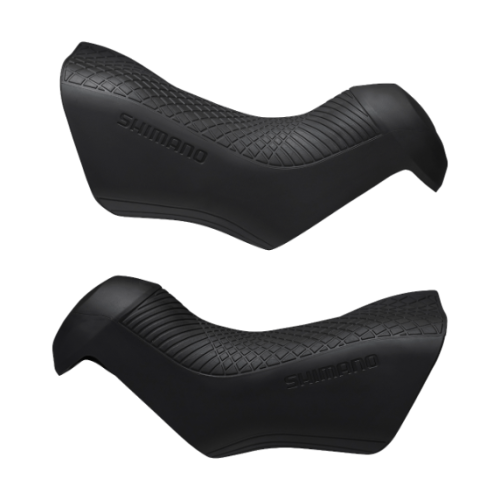 Svarta Shimano reglageskydd för Ultegra ST-R8070, presenterade mot en ljus bakgrund. Detaljerad textur och form framhävs i mjukt ljus, med "SHIMANO" präglat.