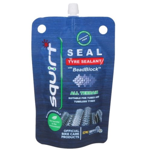 Närbild av Squirt Seal punkteringsvätska i en blå påse, som betonar dess "Ammoniakfri" formula, lämplighet för både tub- och slanglösa däck samt dess miljövänliga egenskaper. Bra ljus framhäver produktinformationen.