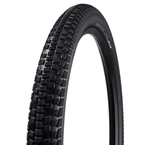 Närbild av Specialized Rhythm Lite däck, modell 12"-16". Svarta däckets mönster visas detaljerat under starkt ljus, framhävande dess slitstarka konstruktion lämplig för barncyklar.