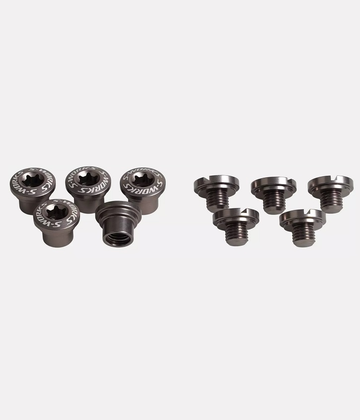 S-Works-drevbultar Närbild av fem Drevbultar S-Works för kolfiber spindel. Detaljerad textur med stark belysning framhäver de fina detaljerna. Professionell produktfotografering visar kvalitet och design.