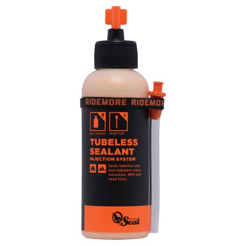 Orange Seal Tubeless-vätska i en vit flaska med en svart etikett.