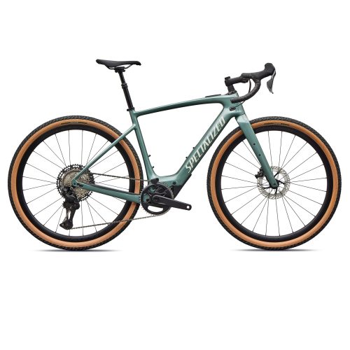 Specialized Turbo Creo SL 2 Expert kolfiber elcykel visas i profil mot en vit bakgrund. Däcken har en distinkt brun färgton som kontrasterar mot den matta grönblå ramen. Bra ljus framhäver detaljerna.