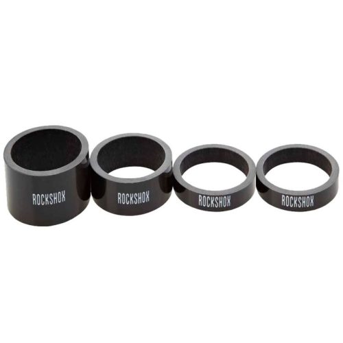 Fyra Rock Shox distanser i kolfiber för 1 1/8" gaffelrör, varierande i storlek.