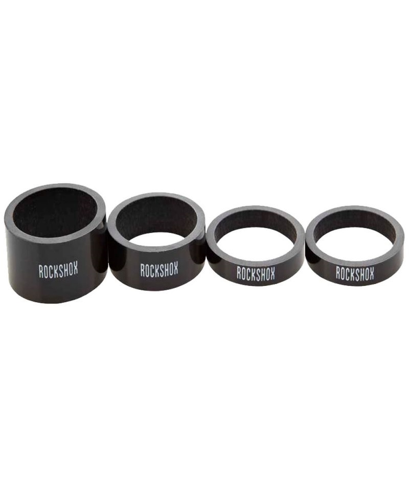 RockShox-Carbon-Spacer-Set Fyra Rock Shox distanser i kolfiber för 1 1/8" gaffelrör, varierande i storlek.