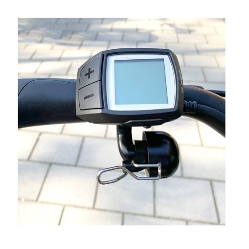 Närbild av ett cykelstyre med Ringklocka Widek Paperclip svartklocka monterad under en digital display med plus- och minusknappar, mot en bakgrund av en kaklad trottoar.